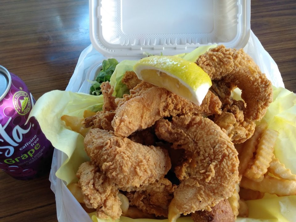 Takeaway containers beside a fish and chips counter.