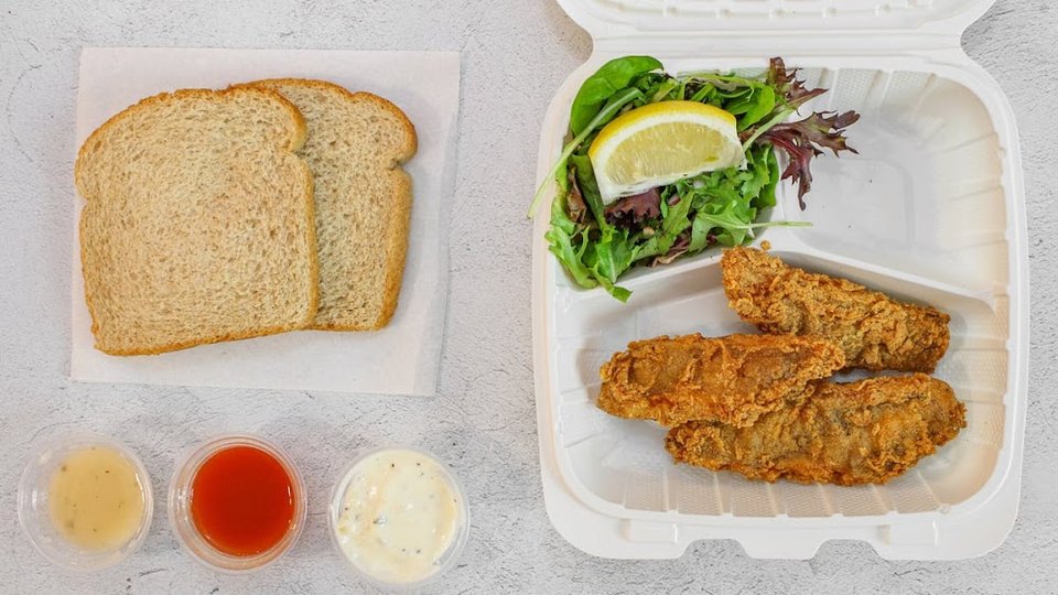 Menu board with fish combos and sides.